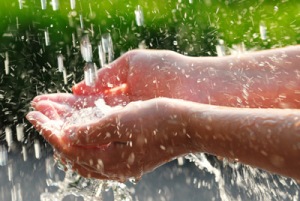 Hands with water splashing off them